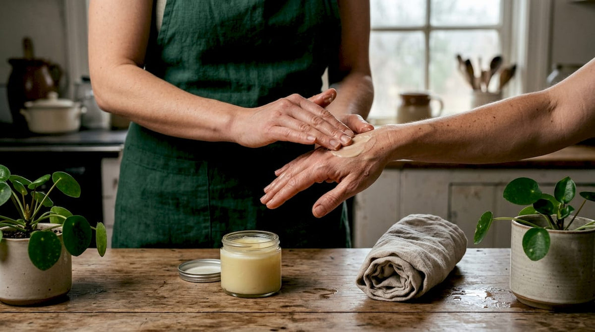 Hands applying tallow balm on skin
