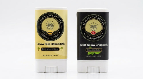 Two lip balm sticks from Lord's Love Butter on a white background. The left stick is labeled Tallow Sun Balm Stick with a pale yellow label, and the right stick is labeled Mint Tallow Chapstick with a black label.